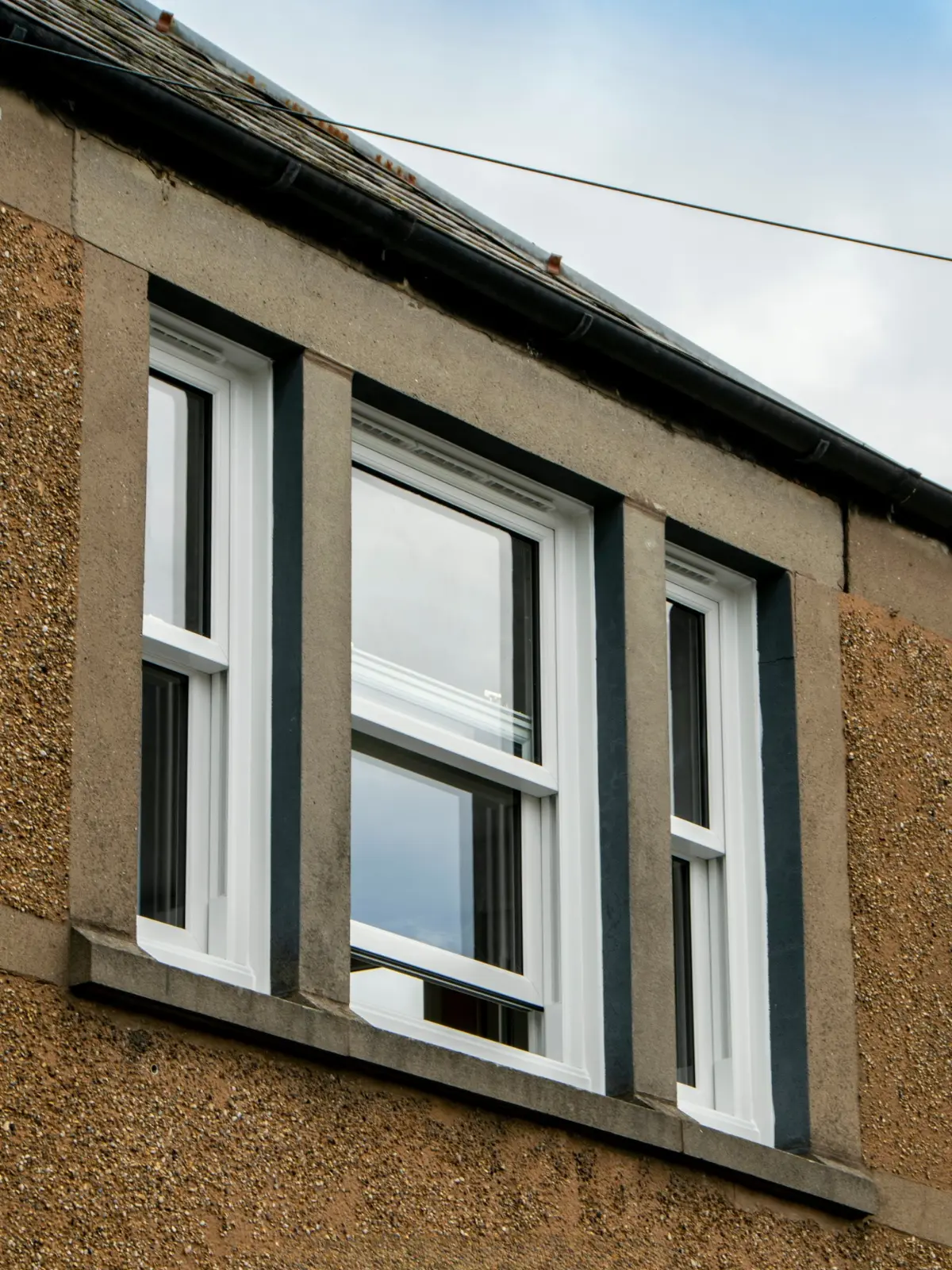 White uPVC sliding sash window installation, Dundee